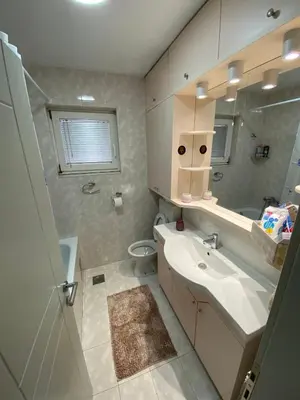 a bathroom with a sink and a toilet and a mirror at Santa Barbara Apartment in Belgrade