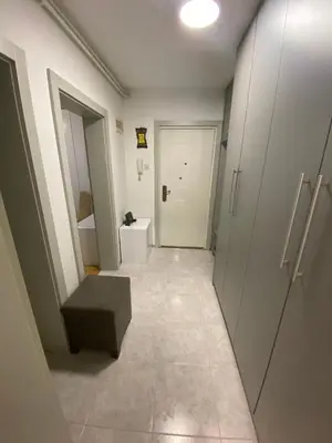 a hallway of a bathroom with a toilet and a stool at Santa Barbara Apartment in Belgrade