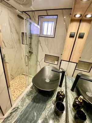 a bathroom with a sink and a shower at Santa Barbara Apartment in Belgrade