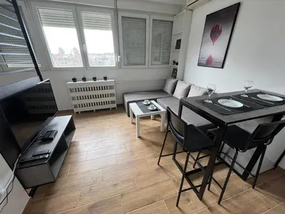 a living room with a table and a couch at Apartment 55 Belgrade in Belgrade