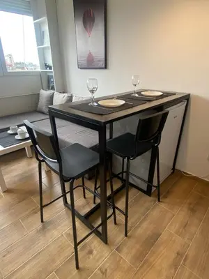 a dining room table with chairs and wine glasses on it at Apartment 55 Belgrade in Belgrade