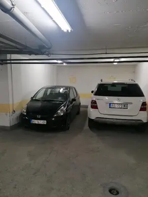 two cars are parked in a parking garage at Belgrade apartment Skadarlija in Belgrade