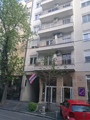 a red car parked in front of a building at Belgrade apartment Skadarlija in Belgrade