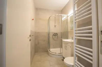 a bathroom with a shower and a toilet and a sink at Belgrade apartment Skadarlija in Belgrade