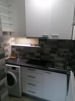 a kitchen with white cabinets and a washing machine at Belgrade apartment Skadarlija in Belgrade