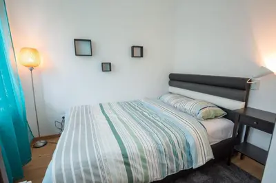 a bedroom with a bed and a table with a lamp at Belgrade apartment Skadarlija II in Belgrade