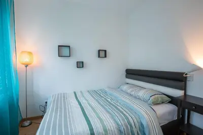 a bedroom with a bed and a table and a lamp at Belgrade apartment Skadarlija II in Belgrade