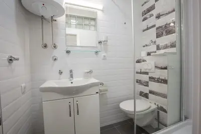 a white bathroom with a sink and a toilet at Belgrade apartment Skadarlija II in Belgrade