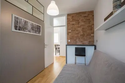 a living room with a couch and a brick wall at Belgrade apartment Skadarlija II in Belgrade