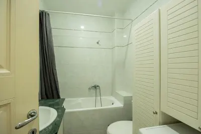 a bathroom with a toilet and a tub and a sink at Belgrade Center Apartment Lux II in Belgrade