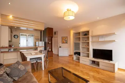 a living room with a couch a table and a television at Belgrade Center Apartment Lux II in Belgrade