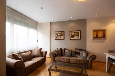 a living room with two couches and a table at Belgrade Center Apartment Lux II in Belgrade