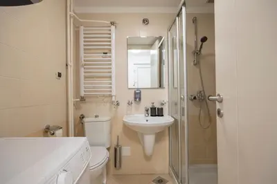 a bathroom with a toilet and a sink and a shower at Belgrade Center Apartment Skadarlija III in Belgrade