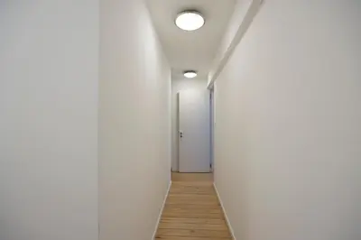 an empty corridor with white walls and a white door at Belgrade Center Apartment Skadarlija III in Belgrade