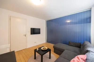 a living room with a couch and a table at Belgrade Center Apartment Skadarlija III in Belgrade