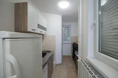 a white kitchen with a sink and a dishwasher at Belgrade Center Apartment Skadarlija III in Belgrade