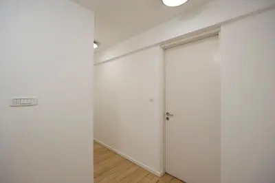 a room with white walls and a sliding door at Belgrade Center Apartment Skadarlija III in Belgrade