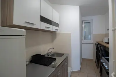 a kitchen with a sink and a laptop on a counter at Belgrade Center Apartment Skadarlija III in Belgrade