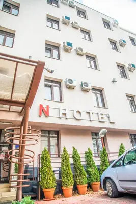 a hotel with a car parked in front of it at Hotel N in Belgrade