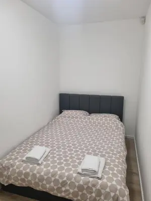 a bedroom with a bed with two towels on it at stan Slavija in Sajmište