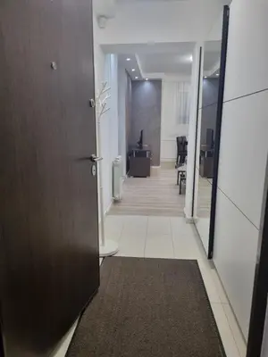 a hallway of an office with a door leading to a hallway at stan Slavija in Sajmište