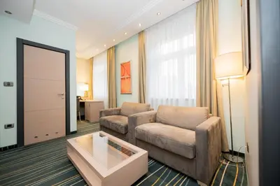 a living room with a couch and a table at Kopernikus Hotel Prag in Belgrade