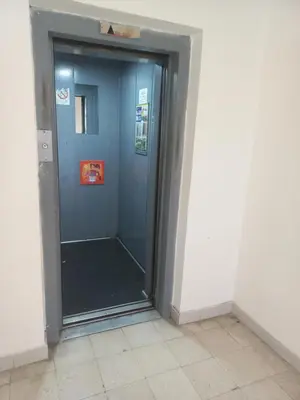 a elevator in a room with a blue door at Sancho Leone in Belgrade
