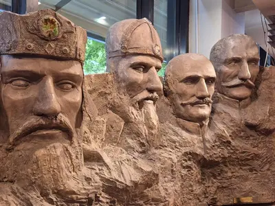a statue of a group of people in mud at Design Hotel Mr President in Belgrade