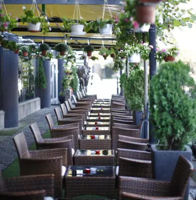 a row of chairs and tables on a patio at Design Hotel Mr President in Belgrade
