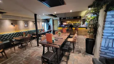 a restaurant with tables and chairs and a bar at Design Hotel Mr President in Belgrade