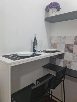 a bar with two chairs and a table with wine glasses at Central Peaceful Nest Belgrade in Belgrade