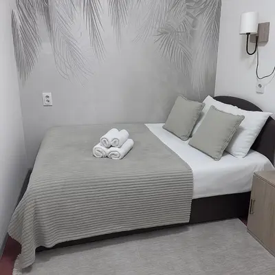 a bedroom with a bed with towels on it at Central Peaceful Nest Belgrade in Belgrade