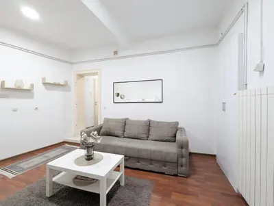 a living room with a couch and a table at Central Peaceful Nest Belgrade in Belgrade
