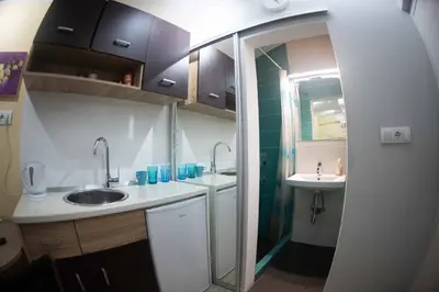 a small bathroom with two sinks and a mirror at House of Vracar 2 in Dušanovac (historical)