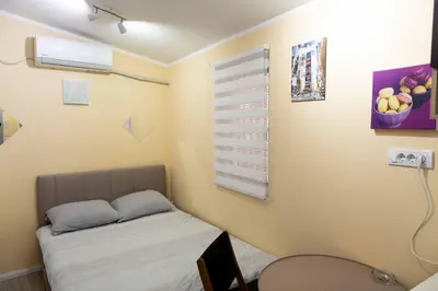 a small bedroom with a bed and a window at House of Vracar 2 in Dušanovac (historical)