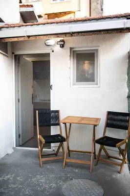 two chairs and a table on a patio at House of Vracar 2 in Dušanovac (historical)