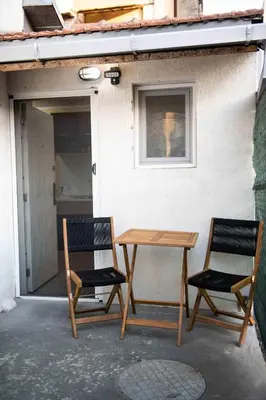 two chairs and a table on a patio at House of Vracar 2 in Dušanovac (historical)