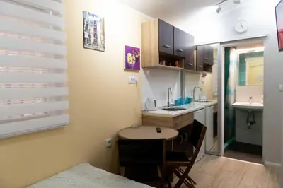 a small kitchen with a table and a sink at House of Vracar 2 in Dušanovac (historical)