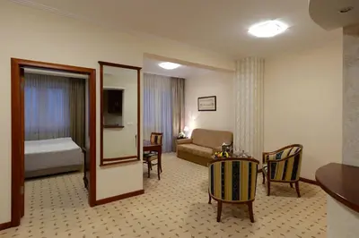 a hotel room with a bed and a living room at Hotel Orasac in Belgrade