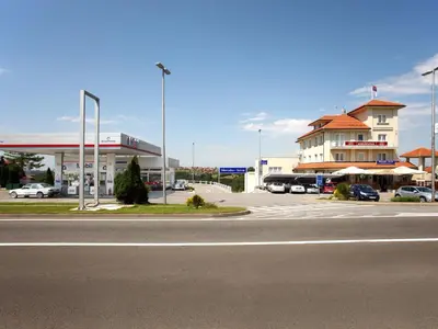 an empty parking lot next to a gas station at Hotel Knezevina in Vranić