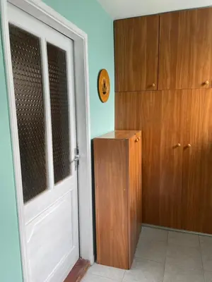 a room with a door and a wooden cabinet at 5min Airport in Surčin