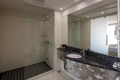 a bathroom with a sink and a large mirror at Nobel Zira Hotel in Belgrade