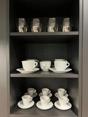 a shelf filled with cups and saucers on plates at Moderna Vračar in Belgrade