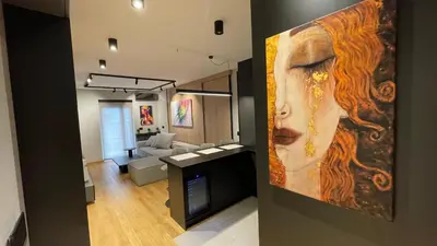 a living room with a large painting of a woman at Moderna Vračar in Belgrade