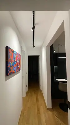 a white hallway with a painting on the wall at Moderna Vračar in Belgrade