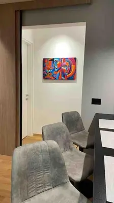 a room with three chairs and a painting on the wall at Moderna Vračar in Belgrade