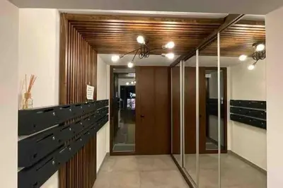 a hallway with glass and wood panels and a ceiling at Moderna Vračar in Belgrade