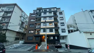 a tall apartment building in the middle of a street at Moderna Vračar in Belgrade