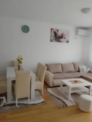 a living room with a couch and a table at Happy Day in Obrenovac