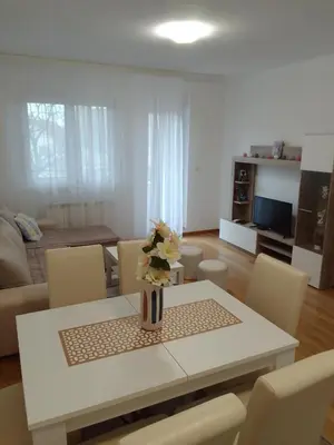 a living room with a white table and chairs at Happy Day in Obrenovac